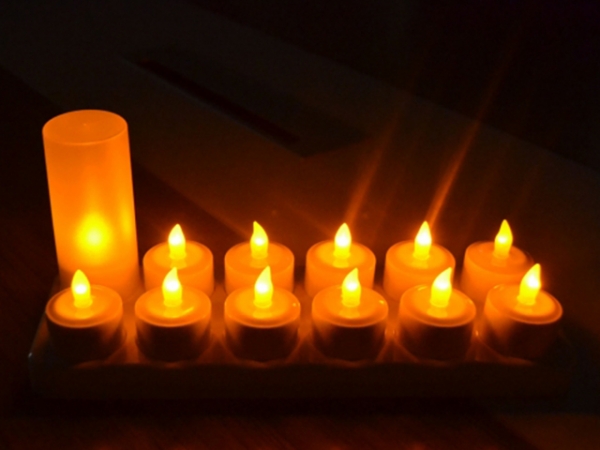 Rechargeable LED tea light candles set with frosted cups and charging hub.