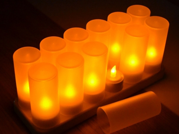 Close-up of flickering yellow rechargeable LED candles.